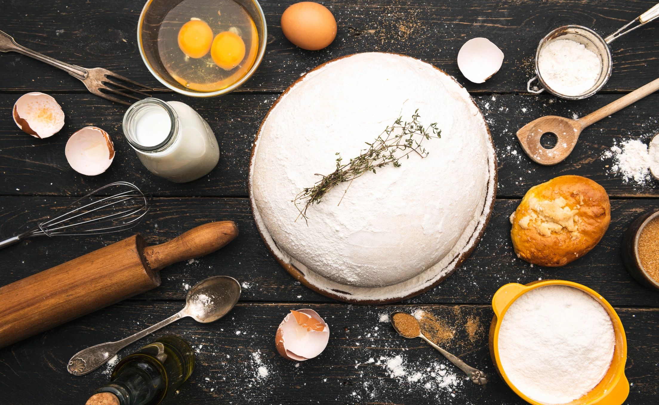 Dough ingredients and kitchen utensils on a work surface