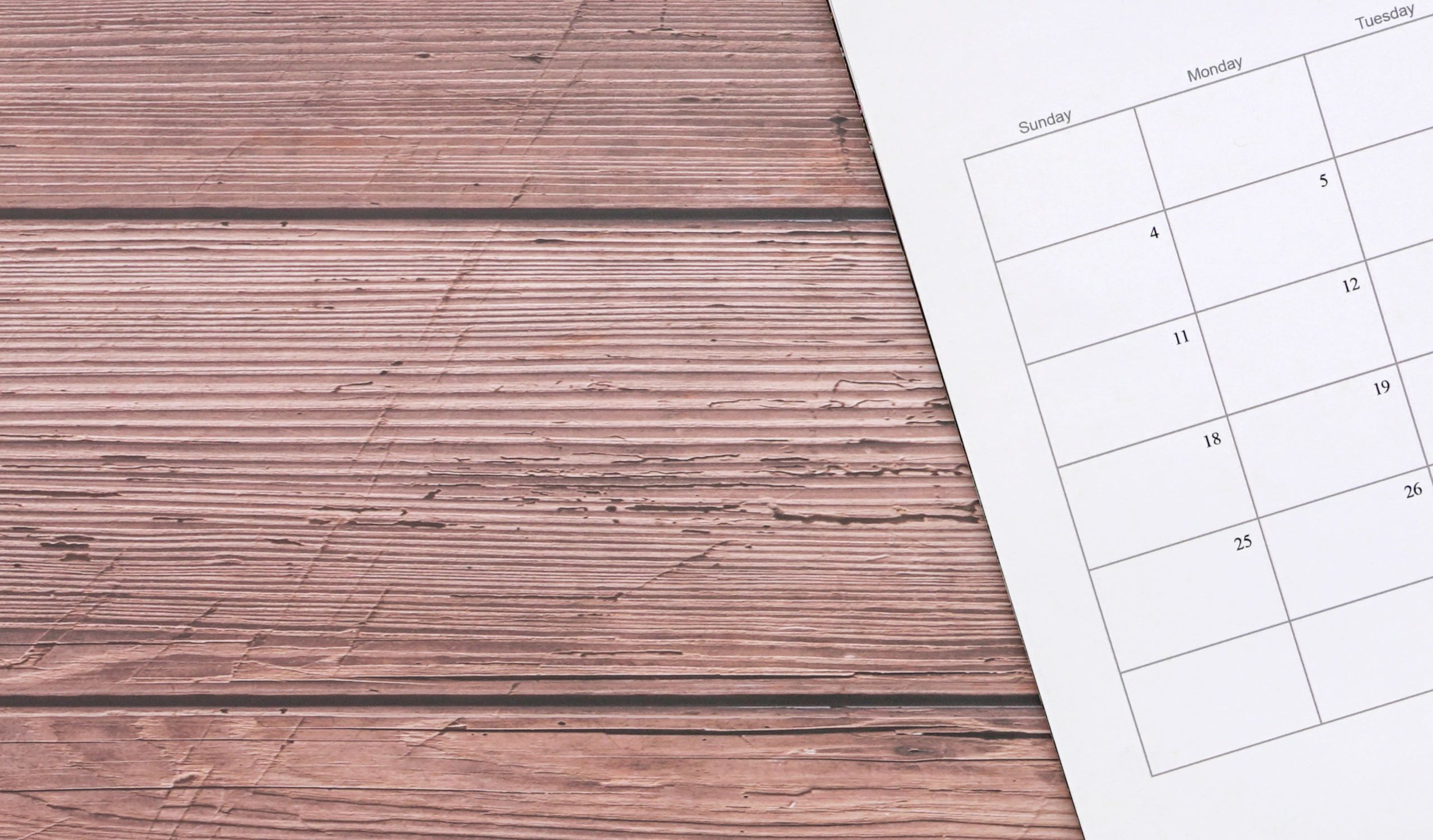 Calendar and planner page on a wooden table