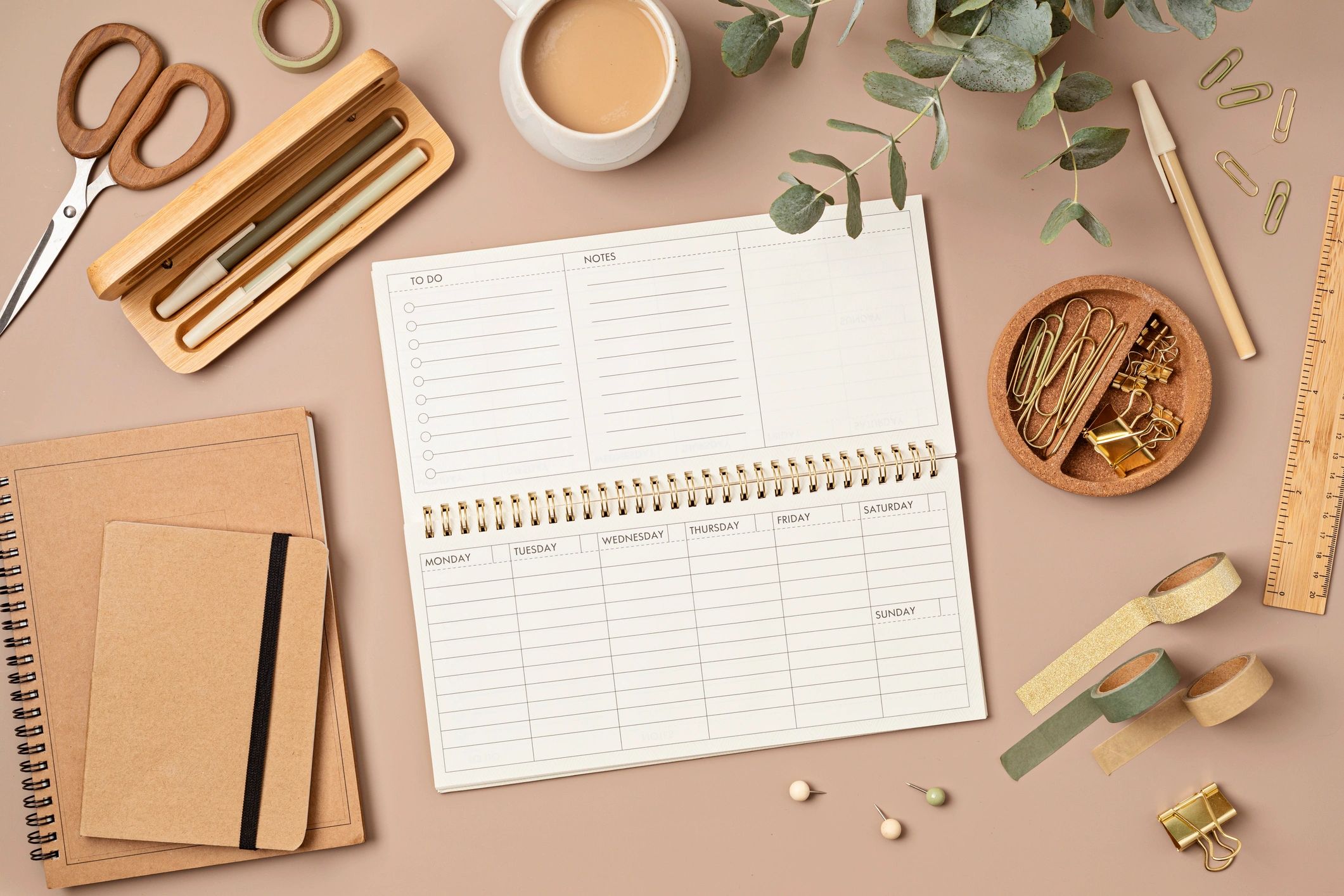 Weekly planner and stationery on a desk