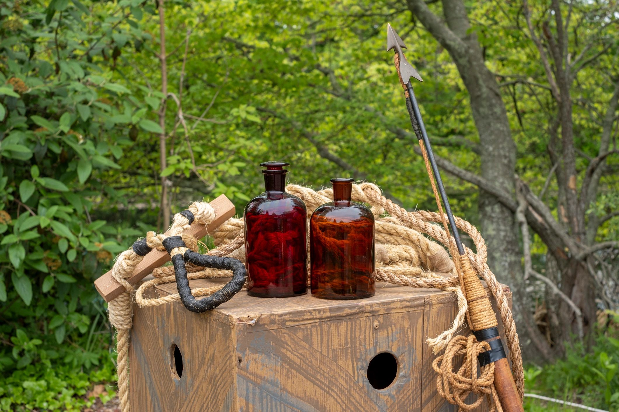 Rustic glass bottles on a weathered wooden crate