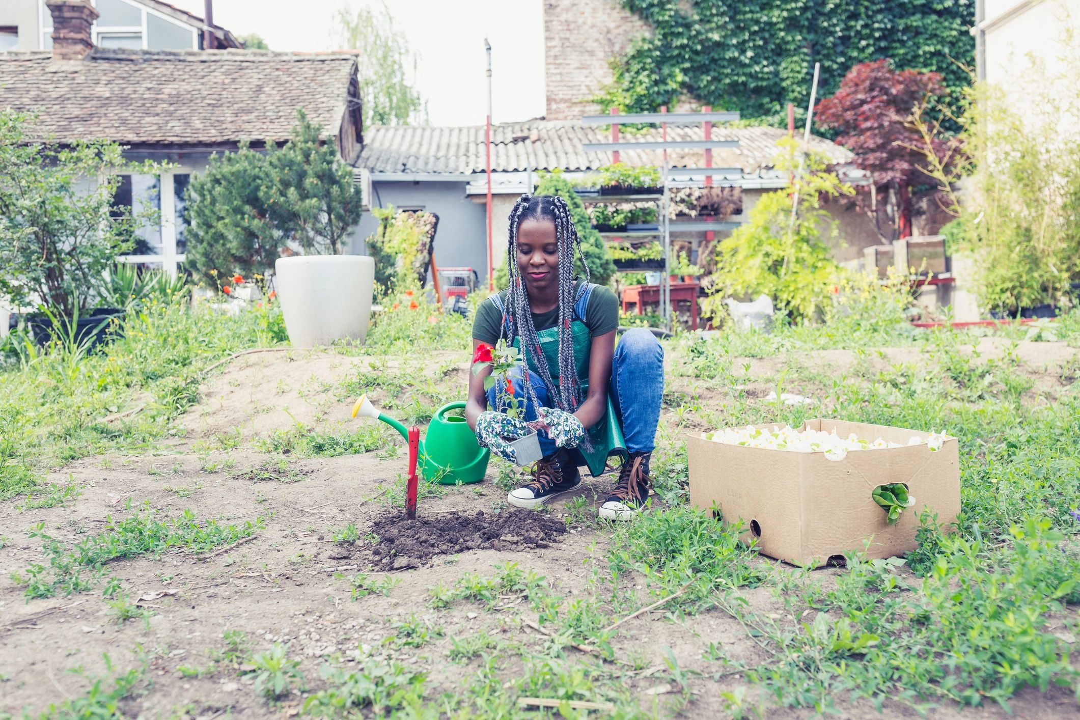 Woman potting plants in the garden